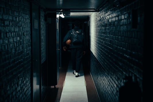 Retin Obasohan walking through the hallway after practive, on his way to weights practice